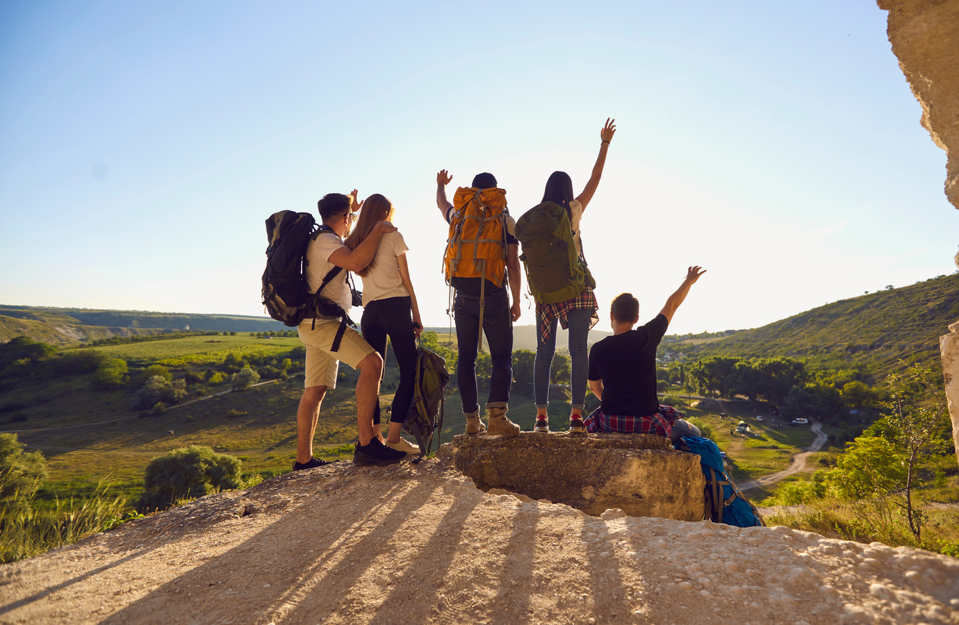 Group of Travelers Celebrating Victory on Hill